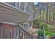 An elevated back deck with stairs leading to the backyard with a view of the lush trees at 2806 Peachtree Walk, Duluth, GA 30096