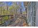 A large back deck with multiple seating areas surrounded by lush trees at 2806 Peachtree Walk, Duluth, GA 30096