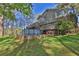 A large backyard with green grass, an above-ground pool, and mature trees on a sunny day at 2806 Peachtree Walk, Duluth, GA 30096