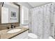 Well-lit bathroom featuring a vanity with granite countertop, modern fixtures, and decorative shower curtain at 2806 Peachtree Walk, Duluth, GA 30096