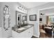 Elegant double vanity bathroom with granite countertops and decor, leading into the main bedroom at 2806 Peachtree Walk, Duluth, GA 30096