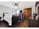 Cozy bedroom featuring dark hardwood floors, a ceiling fan, and a spacious closet at 2806 Peachtree Walk, Duluth, GA 30096