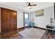 Bright bedroom with hardwood floors, ceiling fan, area rug, closet, and blue furniture set at 2806 Peachtree Walk, Duluth, GA 30096
