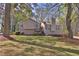 Charming two-story home with a well-maintained lawn and inviting front entrance and mature trees surrounding the home at 2806 Peachtree Walk, Duluth, GA 30096