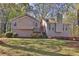 Charming home featuring neutral siding, chimney, and a welcoming entrance with a red door and an American flag at 2806 Peachtree Walk, Duluth, GA 30096