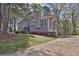 Exterior view of a charming home with a long driveway, lush landscaping, and attached garage on a sunny day at 2806 Peachtree Walk, Duluth, GA 30096