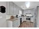 Well-lit kitchen features granite counters, stainless steel appliances, and ample cabinet space at 2806 Peachtree Walk, Duluth, GA 30096