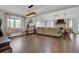Spacious living room with hardwood floors, large windows, and stylish light fixtures at 2806 Peachtree Walk, Duluth, GA 30096