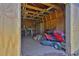 Open shed with lawnmower, lawn tools, and workbench offering convenient storage and workspace at 2806 Peachtree Walk, Duluth, GA 30096