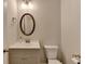 Cozy bathroom with a gray vanity, framed mirror, and toilet at 4569 Grenadine Cir, Acworth, GA 30101