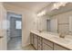 Stylish bathroom with double sinks, modern lighting, with view to an adjoining room at 4569 Grenadine Cir, Acworth, GA 30101