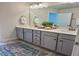 Bathroom with double sinks, and modern fixtures with a view to an adjoining room at 4569 Grenadine Cir, Acworth, GA 30101
