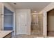 A view of the bathroom with a tiled shower, bathroom vanity, and walk-in closet at 4569 Grenadine Cir, Acworth, GA 30101
