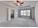 This carpeted bedroom features a ceiling fan and a window with natural light at 4569 Grenadine Cir, Acworth, GA 30101