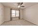 This carpeted bedroom features a ceiling fan and a window with natural light at 4569 Grenadine Cir, Acworth, GA 30101
