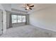 This carpeted bedroom features a ceiling fan and a window with natural light at 4569 Grenadine Cir, Acworth, GA 30101