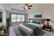 This staged bedroom features a ceiling fan, window with natural light and decor at 4569 Grenadine Cir, Acworth, GA 30101