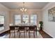 Elegant dining area with large windows, chandelier, and dining table for a cozy and bright setting at 4569 Grenadine Cir, Acworth, GA 30101
