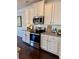 Modern kitchen featuring white cabinets, granite countertops, stainless steel appliances, and tile backsplash at 4569 Grenadine Cir, Acworth, GA 30101