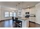 Bright kitchen island featuring granite countertops, pendant lighting, and stainless steel appliances at 4569 Grenadine Cir, Acworth, GA 30101