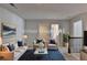 Comfortable staged living room with neutral decor, seating and area rug at 4569 Grenadine Cir, Acworth, GA 30101