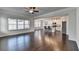 Open-concept living room featuring hardwood floors, large windows, and seamless flow to the kitchen at 4569 Grenadine Cir, Acworth, GA 30101