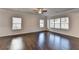 Spacious living room with hardwood floors, crown molding, and large windows providing ample natural light at 4569 Grenadine Cir, Acworth, GA 30101