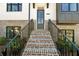 Inviting townhome entrance featuring brick stairs, iron railings, and a modern glass-paneled front door at 2822 Evanshire Ave # 111, Duluth, GA 30096