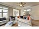 Comfortable living room with modern ceiling fan, hardwood floors, stylish furniture, and lots of sunlight at 2822 Evanshire Ave # 111, Duluth, GA 30096