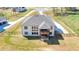 Aerial view of the backyard showcasing a covered patio and balcony, surrounded by a well-maintained lawn at 2900 Waterford Dr, Conyers, GA 30094
