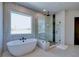 Bright bathroom with a large soaking tub and glass-enclosed shower at 2900 Waterford Dr, Conyers, GA 30094