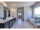 This luxurious bathroom includes dual sinks, a soaking tub, and a large glass-enclosed shower at 2900 Waterford Dr, Conyers, GA 30094