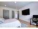 Cozy bedroom with mounted TV, plush rug, and ample closet space at 2900 Waterford Dr, Conyers, GA 30094