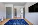Empty bedroom showing interior doors and bright blue rug at 2900 Waterford Dr, Conyers, GA 30094