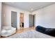 Bright bedroom with a comfortable chair and bathroom access features neutral walls and hardwood floors at 2900 Waterford Dr, Conyers, GA 30094