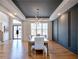Light-filled dining room featuring wood floors and modern hanging light fixture at 2900 Waterford Dr, Conyers, GA 30094