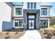 Elegant front entrance featuring a modern door, stone accents, and manicured landscaping at 2900 Waterford Dr, Conyers, GA 30094
