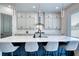 Kitchen featuring island with waterfall countertops, stainless steel appliances, and ample cabinet space at 2900 Waterford Dr, Conyers, GA 30094