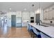 Well-lit open kitchen with waterfall island countertop and stainless steel refrigerator at 2900 Waterford Dr, Conyers, GA 30094