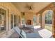 Spacious covered porch with stone columns, fireplace, and lounge chairs at 5394 Brendlynn Dr, Suwanee, GA 30024