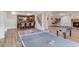 Finished basement boasting a bar, ping pong table, foosball, a fireplace, and ample space at 5394 Brendlynn Dr, Suwanee, GA 30024