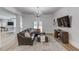 Cozy basement with leather sectional, access to the outdoors, media center, and decorative chandelier at 5394 Brendlynn Dr, Suwanee, GA 30024