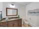 Elegant bathroom with granite countertop and decorative mirror at 5394 Brendlynn Dr, Suwanee, GA 30024