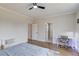 Spacious bedroom with hardwood floors, natural light, a desk, and ceiling fan at 5394 Brendlynn Dr, Suwanee, GA 30024
