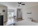 Spacious bedroom with hardwood floors, natural light, a desk, and ceiling fan at 5394 Brendlynn Dr, Suwanee, GA 30024