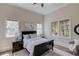 Cozy bedroom with large bed, two windows, and hardwood floors at 5394 Brendlynn Dr, Suwanee, GA 30024