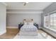 Cozy bedroom with wood-look flooring, neutral paint, and ample natural light at 5394 Brendlynn Dr, Suwanee, GA 30024