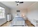 Bedroom featuring natural light, hardwood floors, neutral walls, a ceiling fan and white trim at 5394 Brendlynn Dr, Suwanee, GA 30024