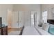 Bright bedroom features a queen bed, hardwood floors, a window, and white trim throughout at 5394 Brendlynn Dr, Suwanee, GA 30024