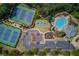 Overhead shot of community amenities, with tennis courts, basketball court, pool, and playground for the residents at 5394 Brendlynn Dr, Suwanee, GA 30024